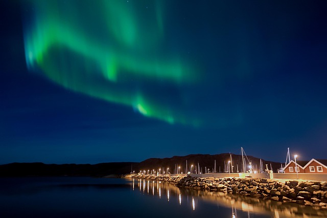 Stunning landscape with aurora borealis, embodying global journeys